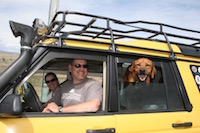 family taking road trip in yellow Land Rover